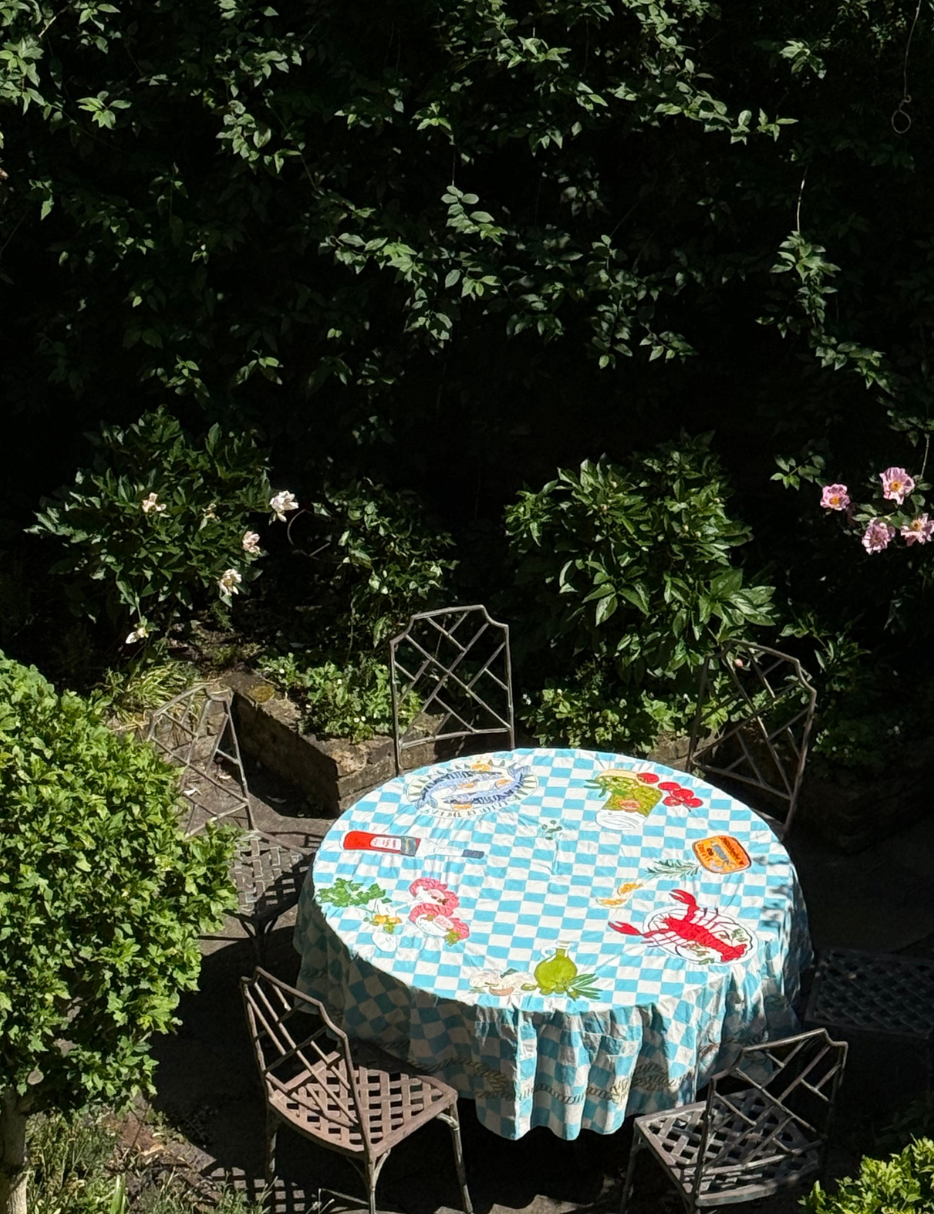 mediterranean tablecloth on a garden table outside 