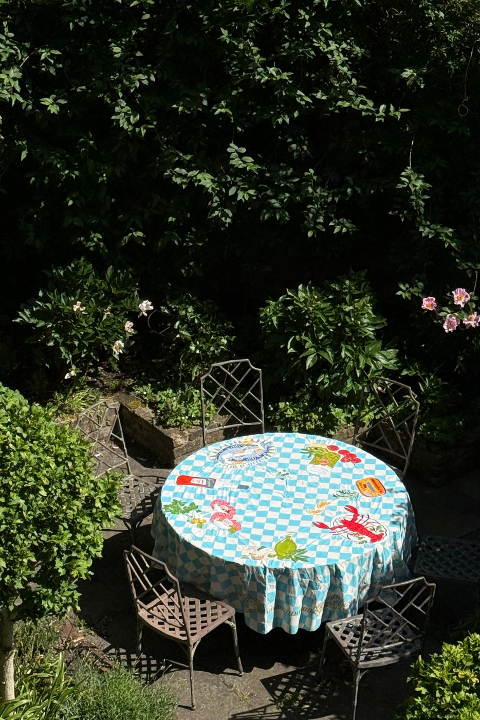 mediterranean tablecloth on a garden table outside 