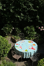 mediterranean tablecloth on a garden table outside 