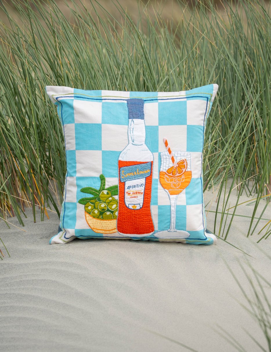 embroidered cushion with aperol and olives 
