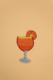 Aperol Spritz coaster, with orange slice. The coaster is made from Jute
