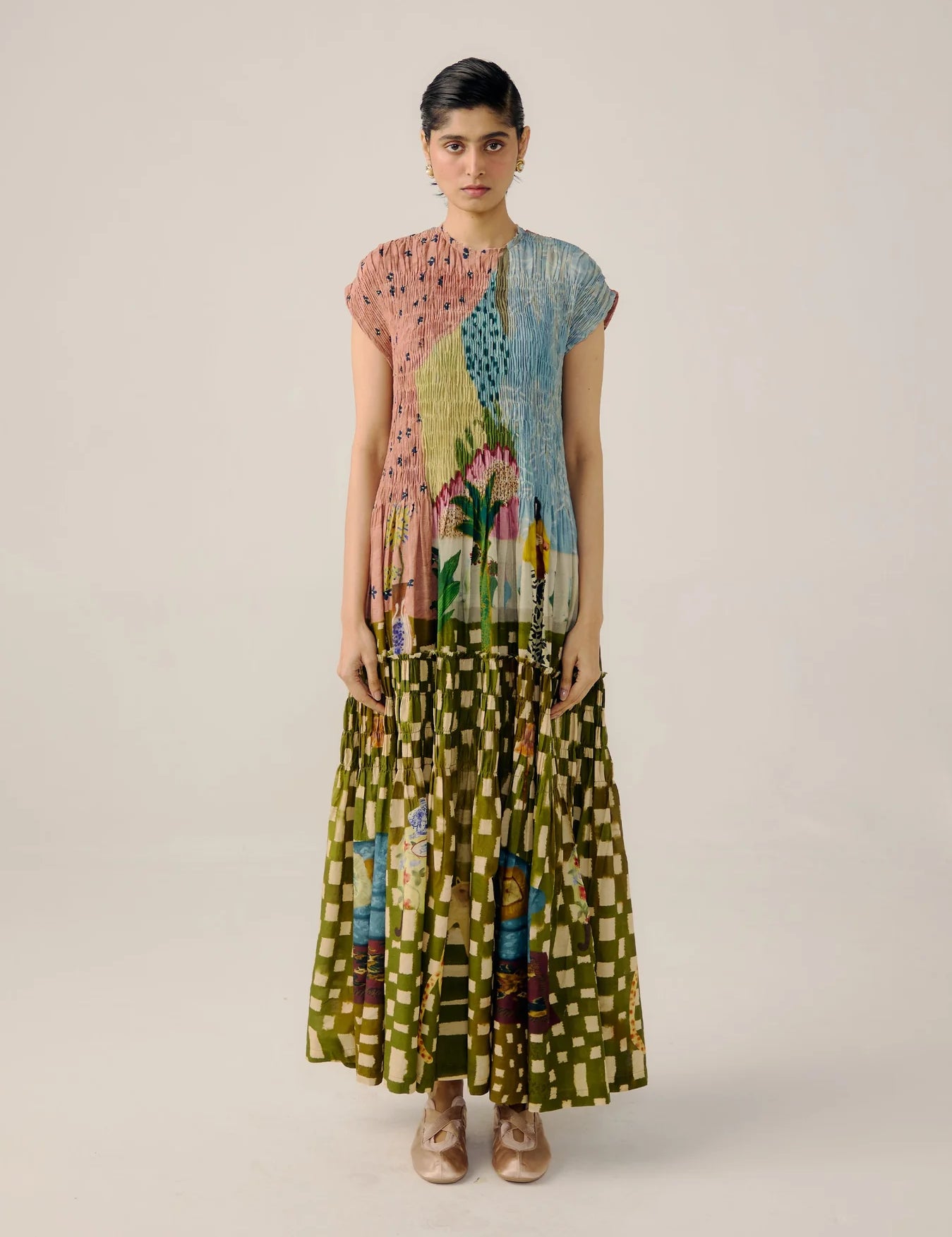 Woman wearing a colorful dress on a plain background