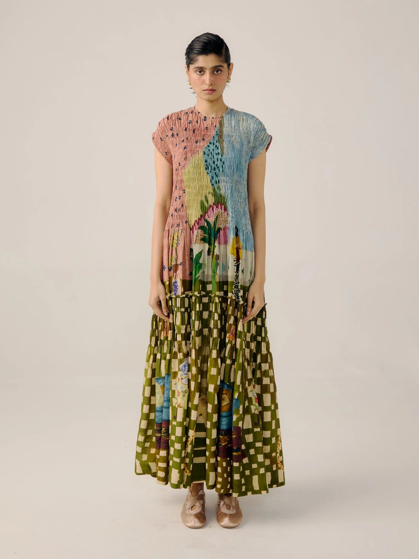 Woman wearing a colorful dress on a plain background
